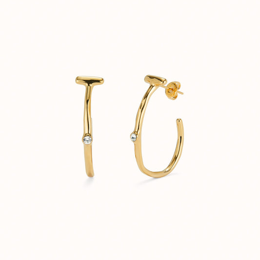 uno de 50 gold plated organic hoop earrings with topaz